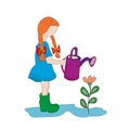 Little girl helps with housework. watering from a watering can indoor plants in pots